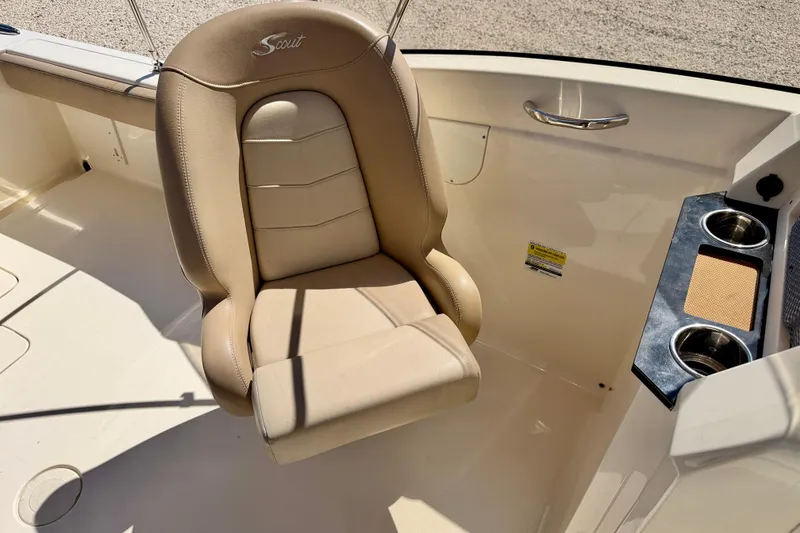 Slide: The Image of 2023 Scout 215 Dorado boat interior with beige seat and cup holders. - 20