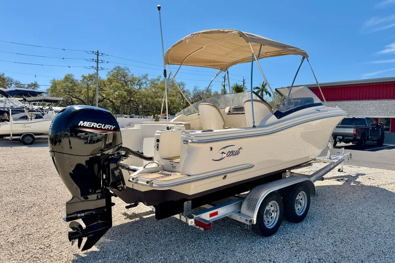 Slide: The Image of 2023 Scout 215 Dorado boat on trailer with Mercury outboard motor, parked outdoors. - 5