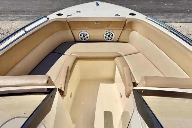 Slide: The Image of 2023 Scout 215 Dorado boat interior with beige seating and speakers. - 9