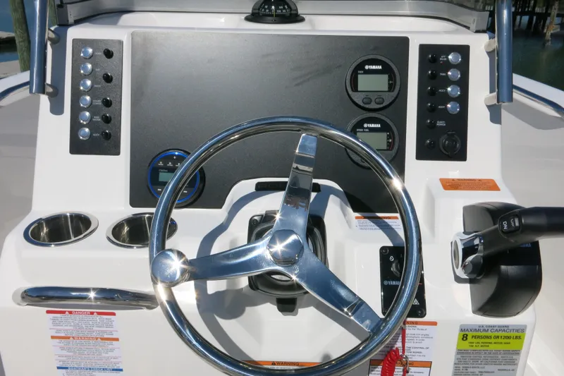 Slide: The Image of 2026 Robalo R180 Center Console dashboard with steering wheel and controls. - 19