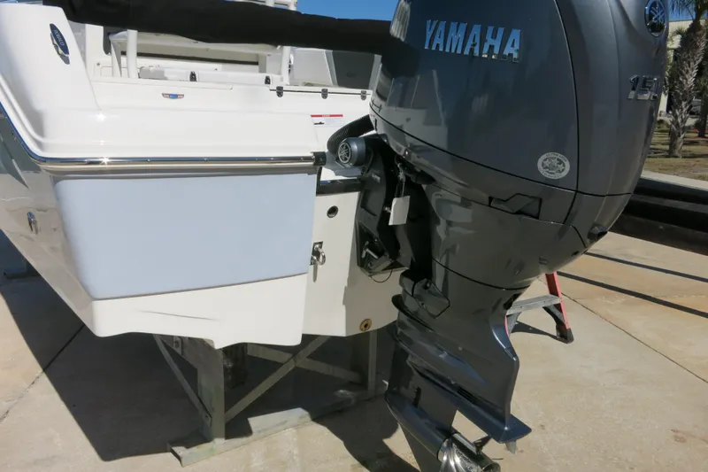 Slide: The Image of 2026 Robalo R180 Center Console with Yamaha outboard motor, docked on a sunny day. - 21