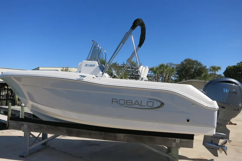 Slide: The Image of 2026 Robalo R180 Center Console boat on display with Yamaha engine. - 5