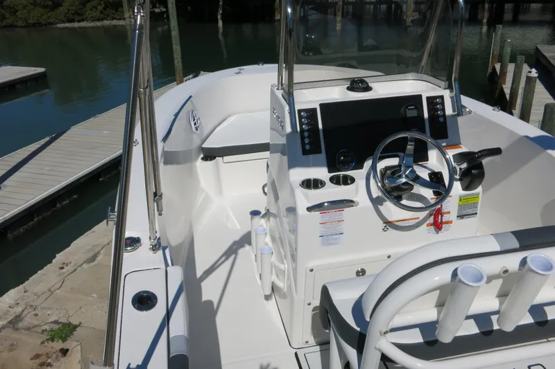 Slide: The Image of 2026 Robalo R180 Center Console boat interior with steering wheel and control panel. - 9