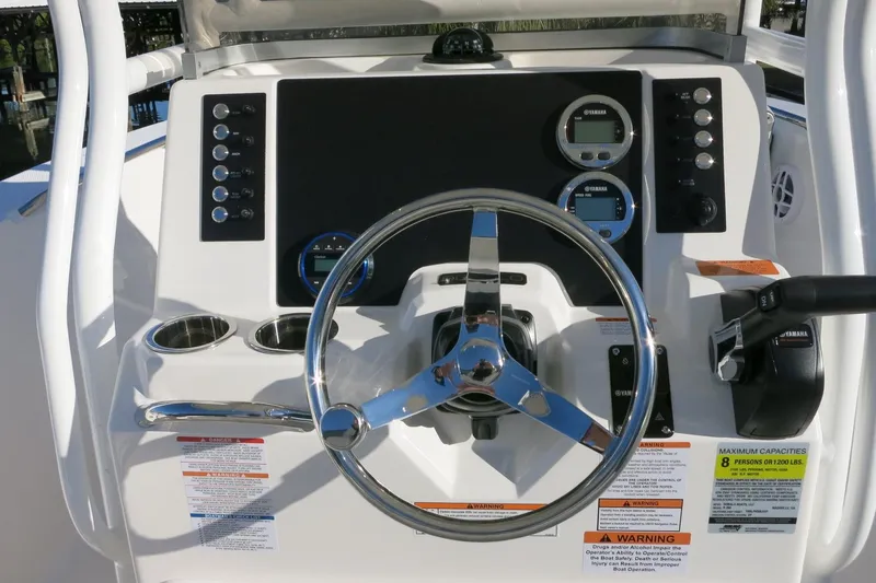 Slide: The Image of 2026 Robalo R200 Center Console boat dashboard with steering wheel and controls. - 17