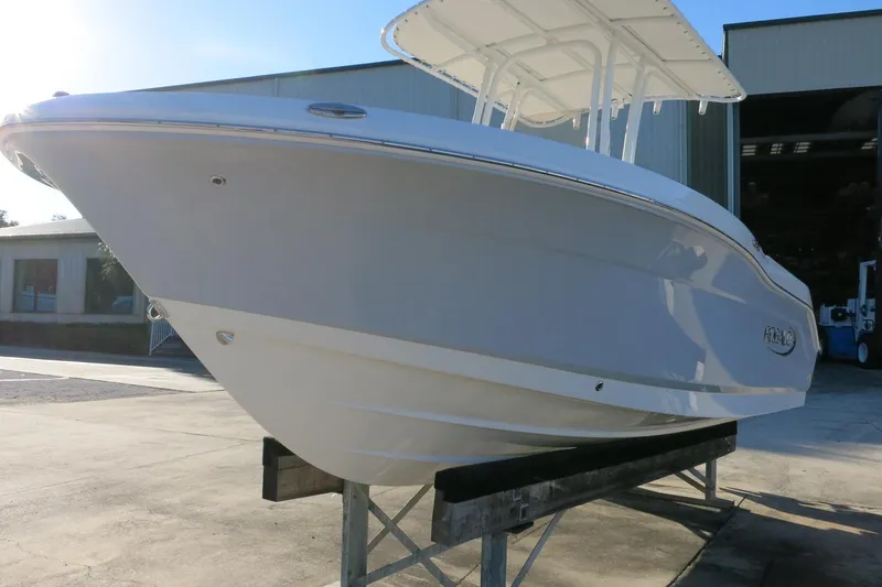 Slide: The Image of 2026 Robalo R200 Center Console boat on display outside a warehouse. - 5