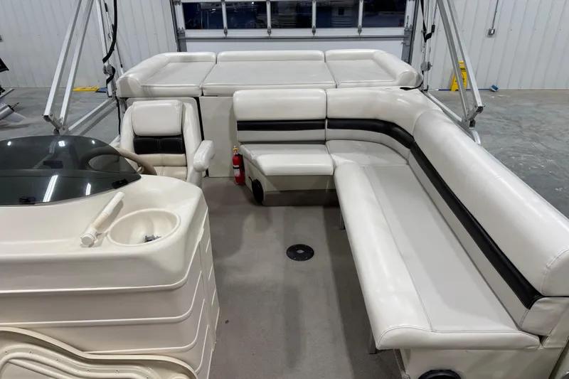 Slide: The Image of Interior of a 2002 Voyager Extreme 25 Cruise boat with white seating and helm. - 17