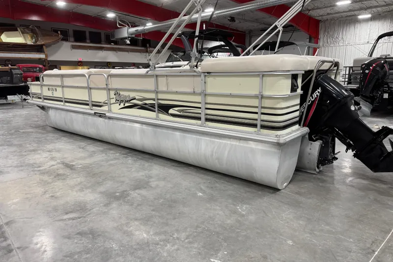 Slide: The Image of 2002 Voyager Extreme 25 Cruise pontoon boat in showroom, featuring Mercury outboard motor. - 4