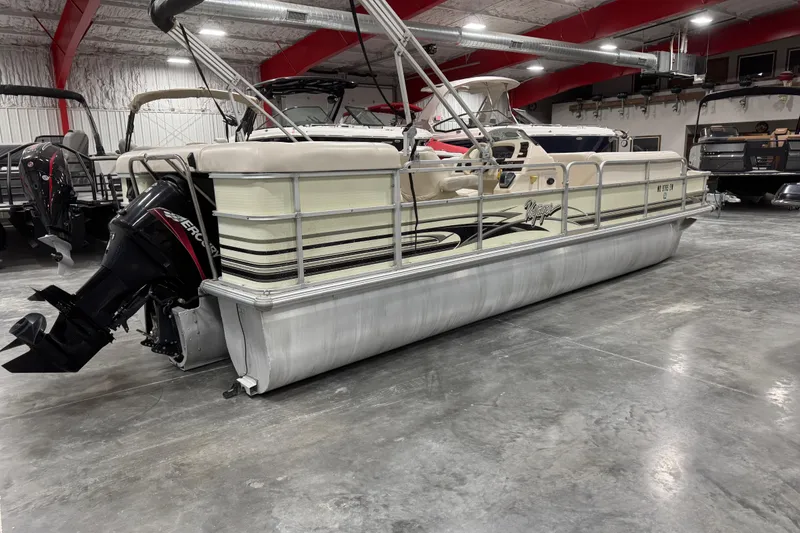 Slide: The Image of 2002 Voyager Extreme 25 Cruise pontoon boat in indoor storage with Mercury outboard motor. - 5