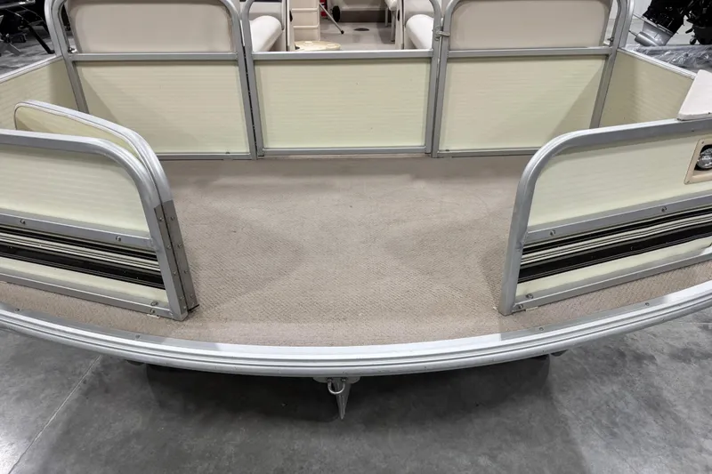 Slide: The Image of 2002 Voyager Extreme 25 Cruise pontoon boat deck with beige carpet and aluminum railings. - 9