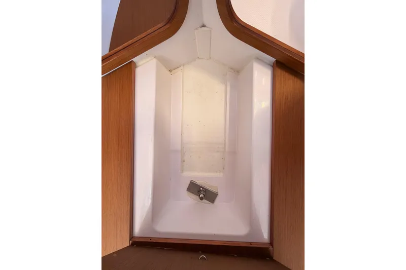 Slide: The Image of Interior view of 2023 Beneteau First 36 sailboat, showcasing sleek wooden and white design. - 100