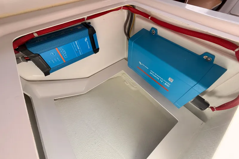 Slide: The Image of Electrical components in a 2023 Beneteau First 36 yacht, featuring blue inverters. - 102
