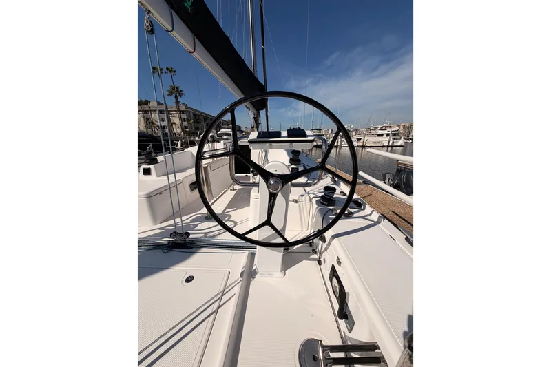 Slide: The Image of 2023 Beneteau First 36 sailboat cockpit with steering wheel, docked in marina. - 14