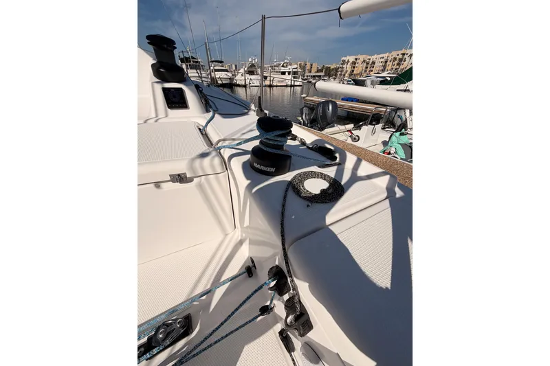 Slide: The Image of 2023 Beneteau First 36 sailboat deck with winches and ropes in marina. - 20