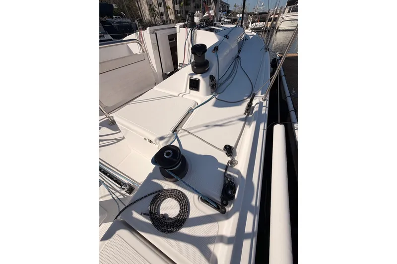 Slide: The Image of 2023 Beneteau First 36 sailboat deck with winches and rigging in marina. - 21