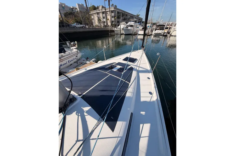 Slide: The Image of 2023 Beneteau First 36 sailboat docked in a marina, showcasing sleek deck design. - 25