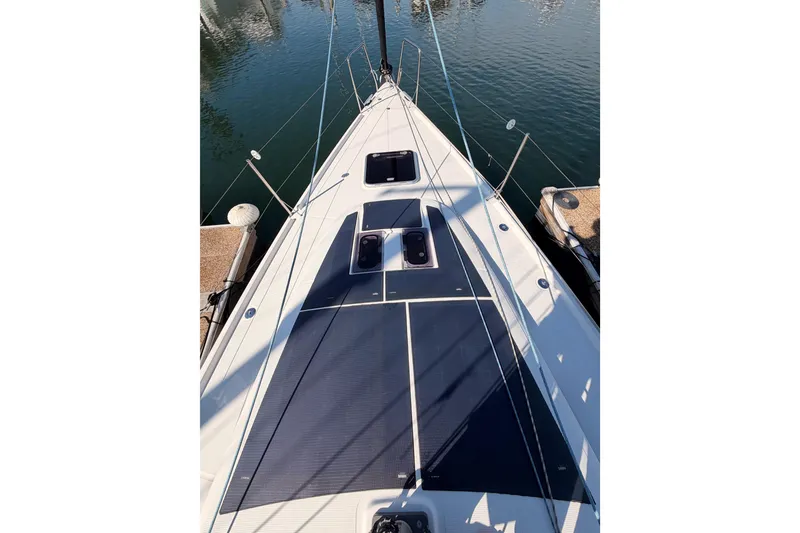 Slide: The Image of 2023 Beneteau First 36 sailboat deck, docked in a marina, showcasing sleek design. - 26