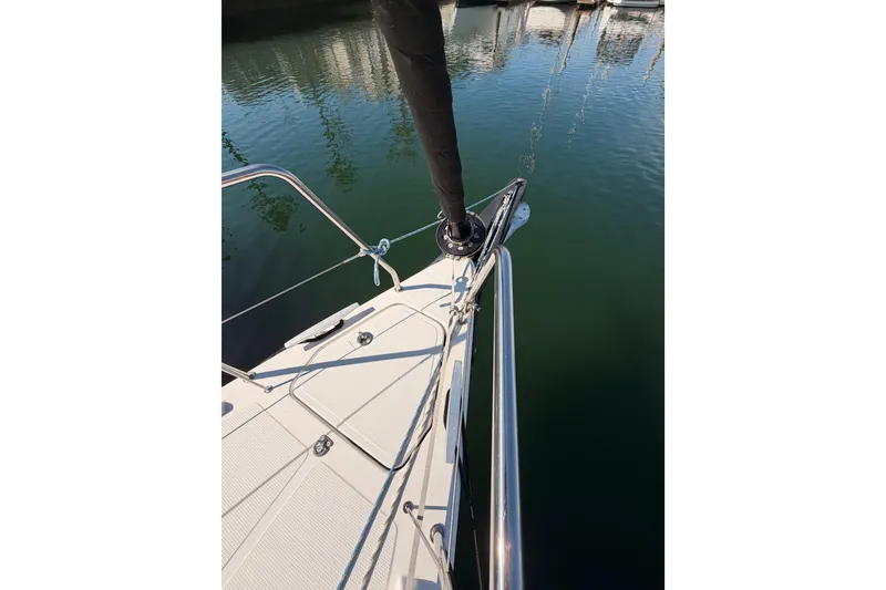 Slide: The Image of Bow view of 2023 Beneteau First 36 sailboat docked in calm waters. - 27