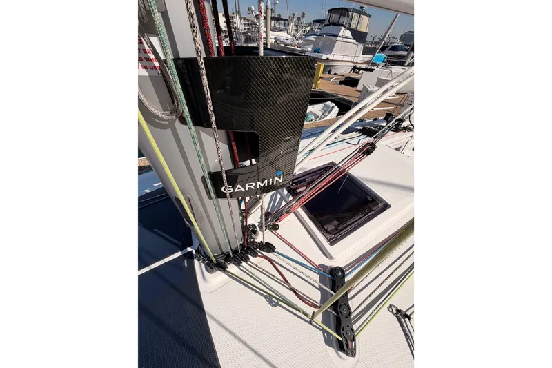 Slide: The Image of 2023 Beneteau First 36 sailboat deck with Garmin equipment and colorful rigging. - 34