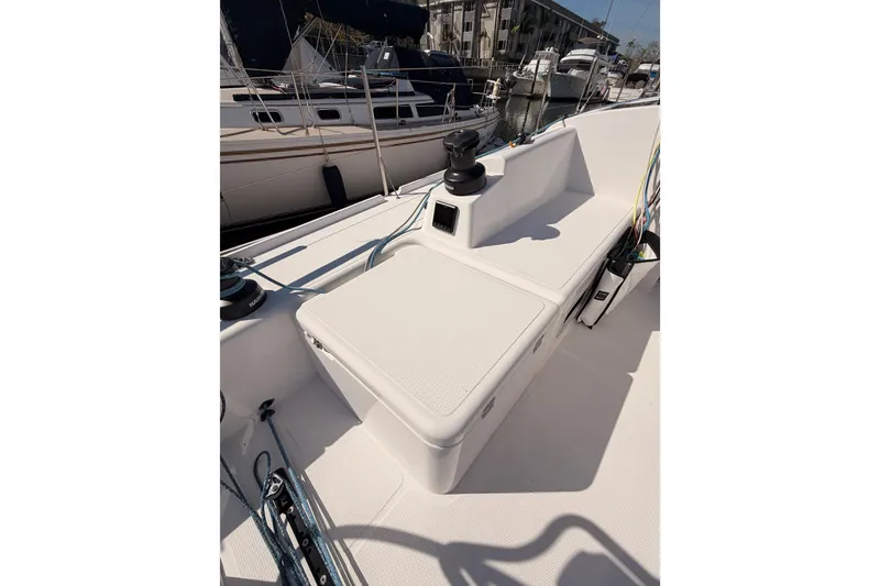 Slide: The Image of 2023 Beneteau First 36 sailboat deck with winch and seating area in marina. - 44