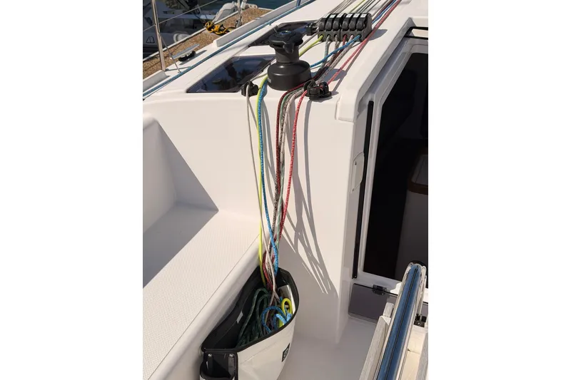 Slide: The Image of 2023 Beneteau First 36 sailboat deck with colorful ropes and winch system. - 50