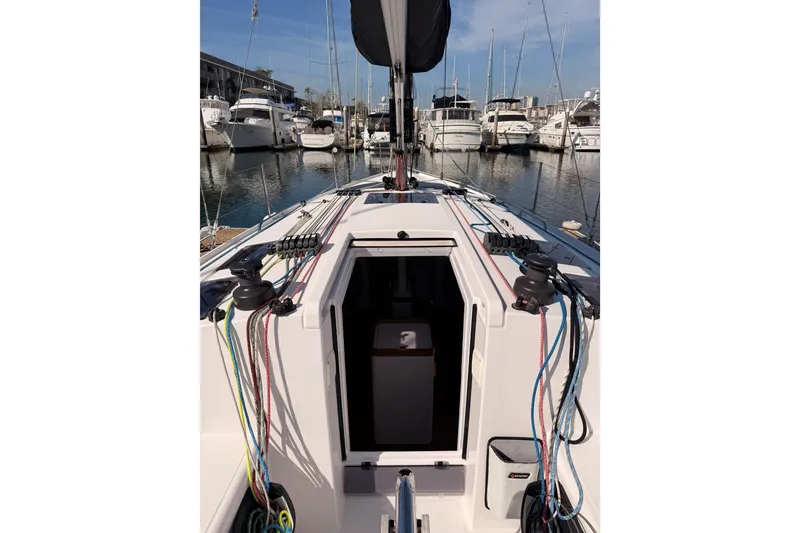 Slide: The Image of 2023 Beneteau First 36 sailboat docked in marina, showcasing deck and rigging. - 51