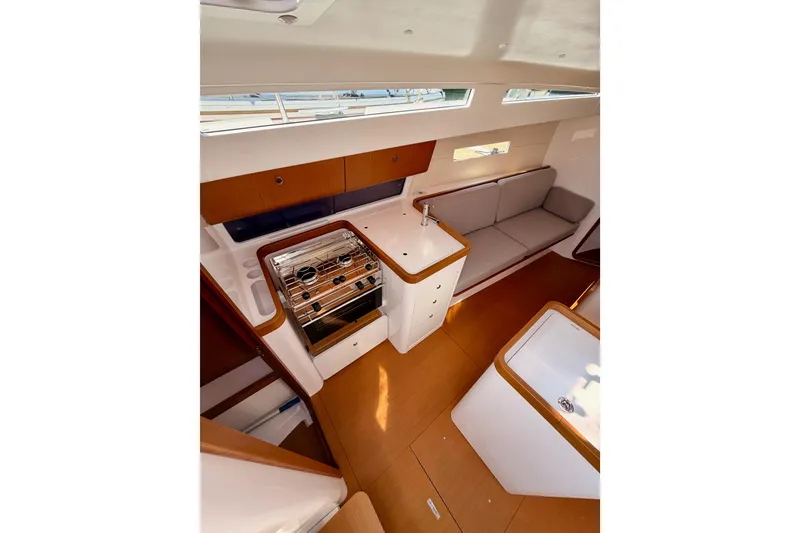 Slide: The Image of Interior of 2023 Beneteau First 36 yacht, featuring modern kitchen and seating area. - 53