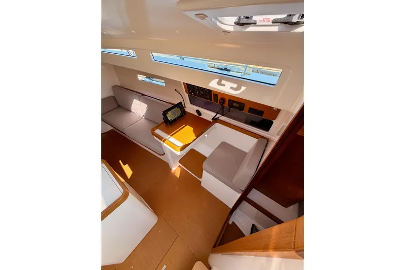 Slide: The Image of Interior of 2023 Beneteau First 36 sailboat, featuring modern seating and navigation equipment. - 54