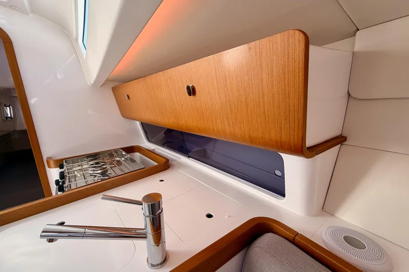 Slide: The Image of Modern kitchen interior of 2023 Beneteau First 36 yacht with sleek wood cabinetry. - 63