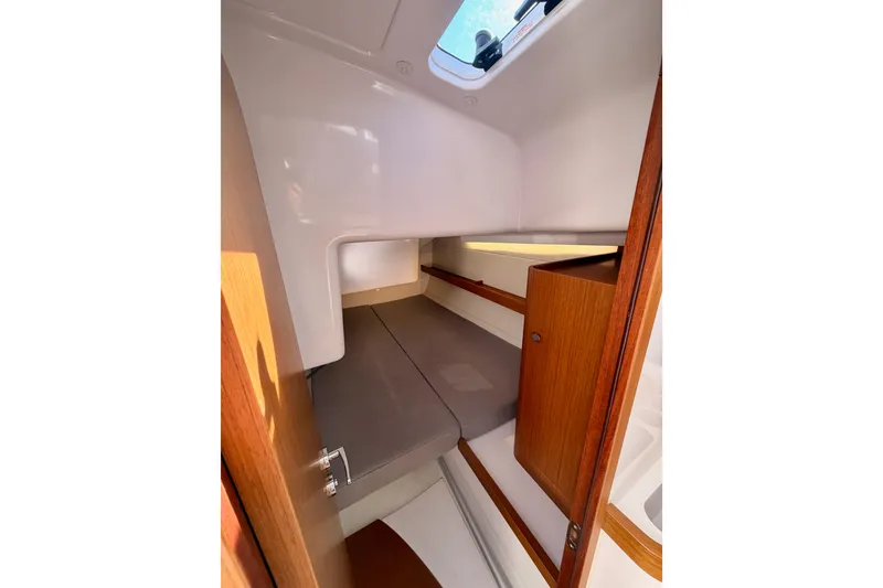 Slide: The Image of 2023 Beneteau First 36 cabin interior with wooden accents and a skylight. - 64