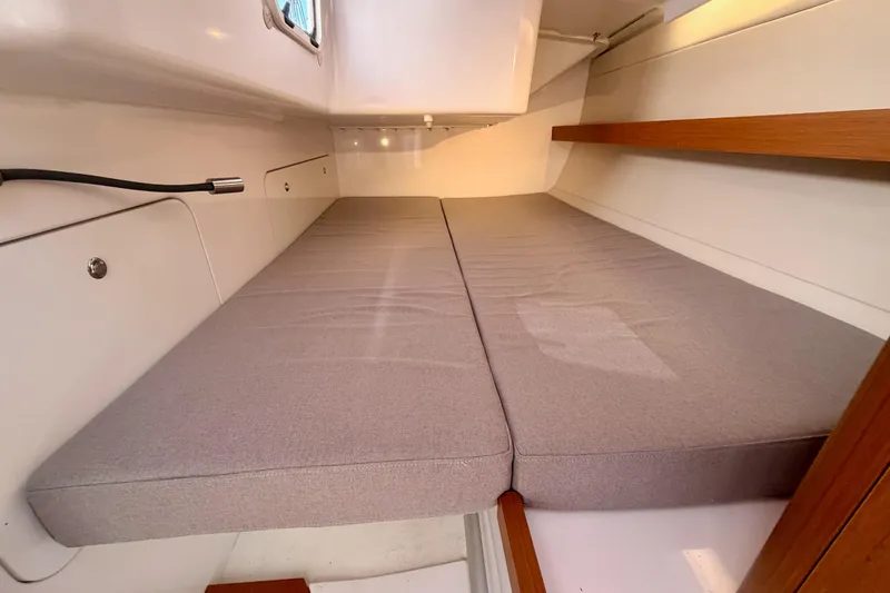 Slide: The Image of Interior cabin of 2023 Beneteau First 36 sailboat with cushioned sleeping area. - 65