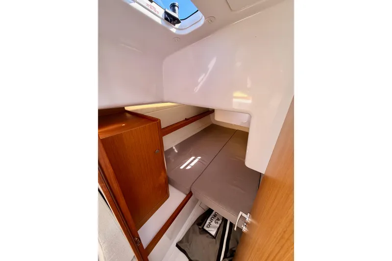 Slide: The Image of 2023 Beneteau First 36 cabin interior with wooden cabinetry and cozy sleeping area. - 67