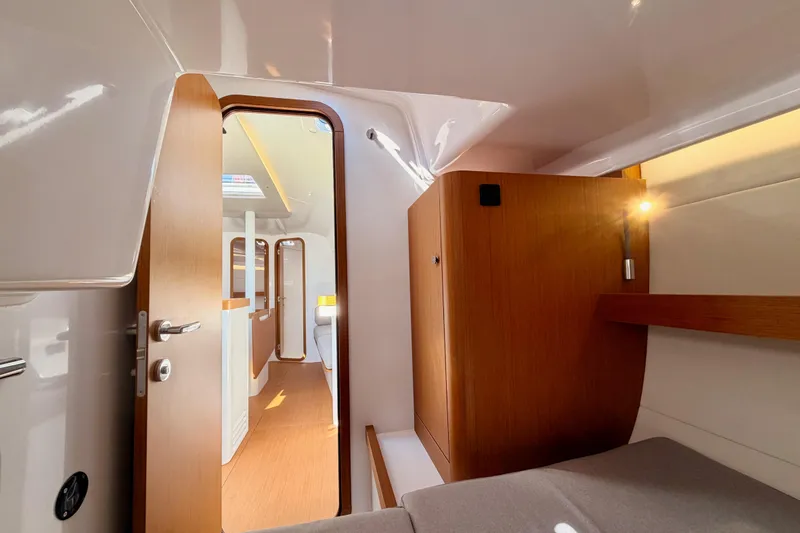 Slide: The Image of 2023 Beneteau First 36 interior cabin with modern wood finish and cozy lighting. - 70
