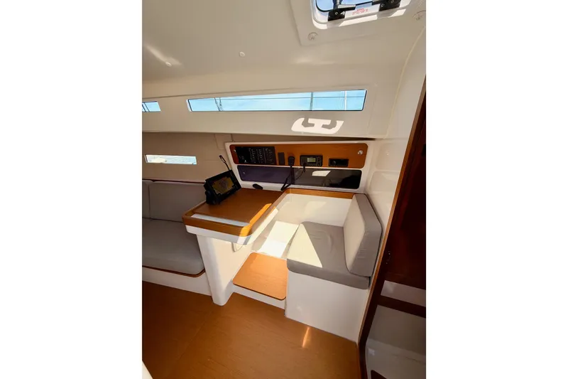 Slide: The Image of Interior of 2023 Beneteau First 36 sailboat, featuring navigation station and seating area. - 71