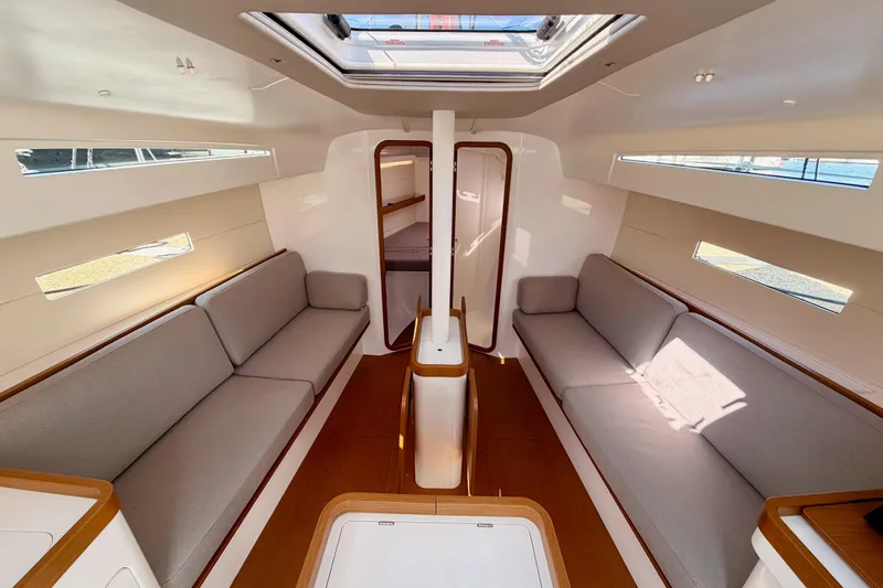 Slide: The Image of Interior of 2023 Beneteau First 36 sailboat, featuring modern seating and skylight. - 77