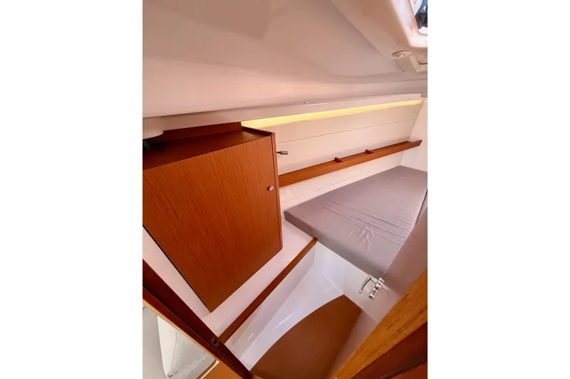 Slide: The Image of 2023 Beneteau First 36 interior cabin with wooden cabinetry and cozy sleeping area. - 84