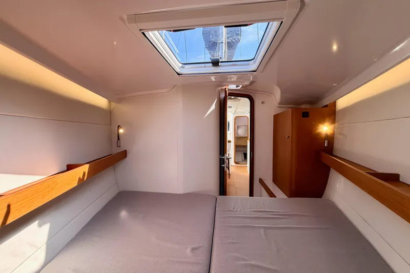 Slide: The Image of Interior cabin of 2023 Beneteau First 36 yacht, featuring modern design and skylight. - 88