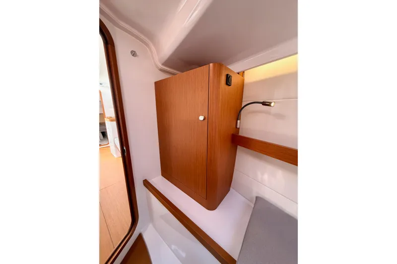 Slide: The Image of Interior of 2023 Beneteau First 36 yacht, featuring wooden cabinetry and modern lighting. - 89