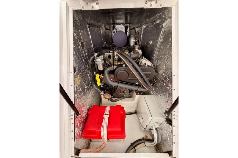 Slide: The Image of Engine compartment of 2023 Beneteau First 36 sailboat, featuring a compact marine engine. - 94
