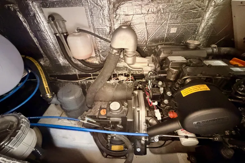 Slide: The Image of Engine compartment of 2023 Beneteau First 36 sailboat, showcasing mechanical components and insulation. - 95