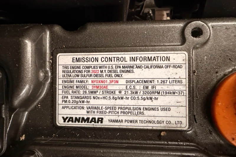 Slide: The Image of ```json { "alt_text": "Yanmar engine emission control label on 2023 Beneteau First 36." } ``` - 96