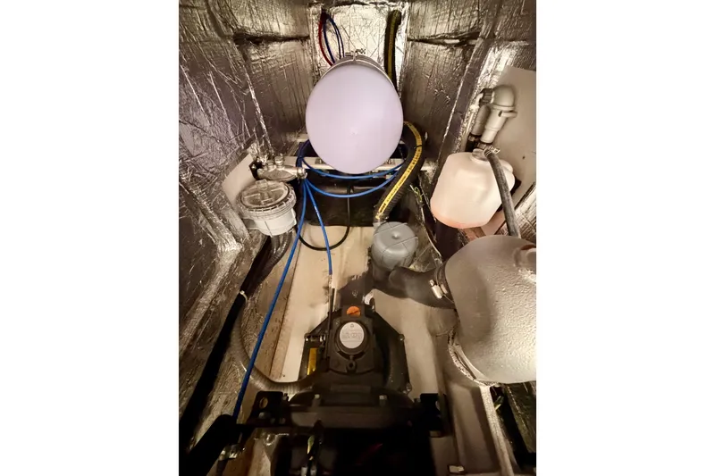 Slide: The Image of Engine compartment of 2023 Beneteau First 36 sailboat, showcasing mechanical components. - 98