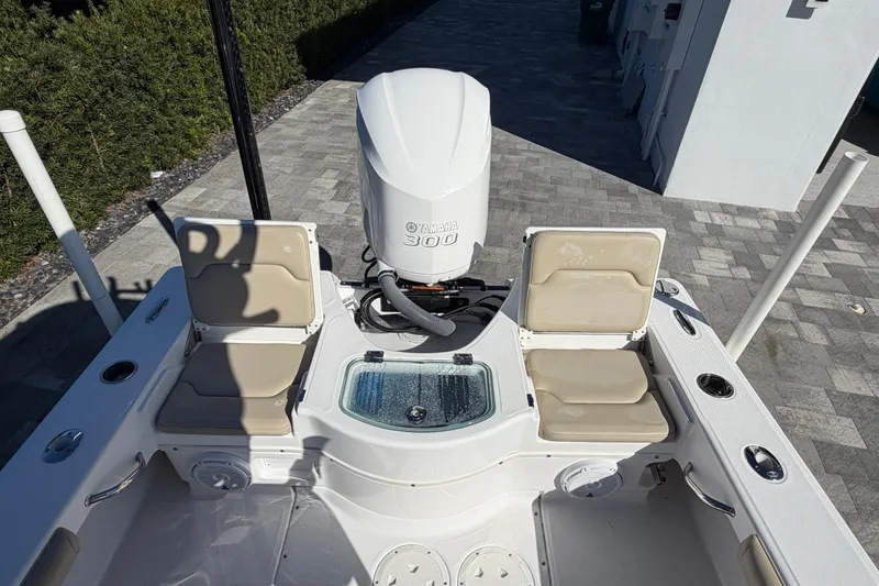 Slide: The Image of 2019 Everglades 243 Center Console boat with Yamaha 300 engine, featuring cushioned seating. - 11