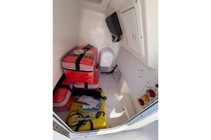 Slide: The Image of Interior of 2019 Everglades 243 Center Console boat with storage and safety equipment. - 12