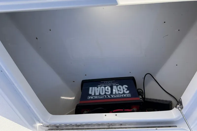 Slide: The Image of Storage compartment of 2019 Everglades 243 Center Console with Dakota Lithium battery. - 14