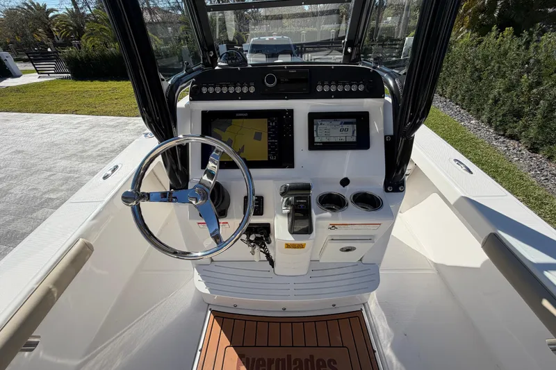 Slide: The Image of 2019 Everglades 243 Center Console boat dashboard with steering wheel and navigation system. - 6