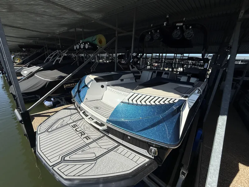 Slide: The Image of 2018 Nautique G23 boat in a covered dock. - 13
