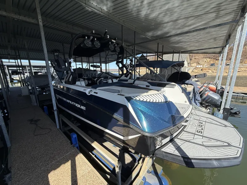 Slide: The Image of 2018 Nautique G23 boat docked, side view. - 18