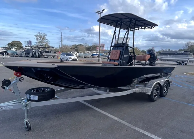 Slide: The Image of 2026 Avid 20CC Rogue boat on trailer parked outdoors. - 6