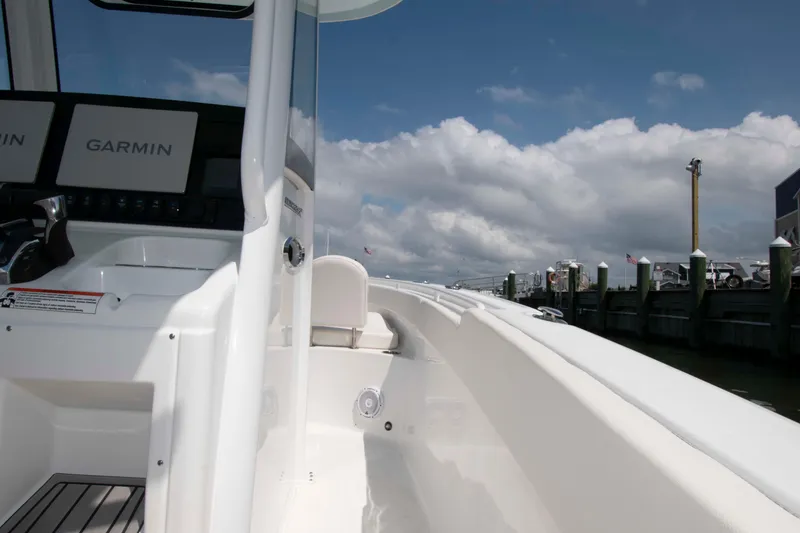 Slide: The Image of 2023 Sea Hunt Ultra 265 SE boat with Garmin displays, docked under a cloudy sky. - 17