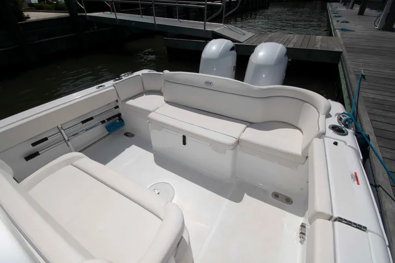 Slide: The Image of 2023 Sea Hunt Ultra 265 SE boat interior with white seating and twin engines. - 3